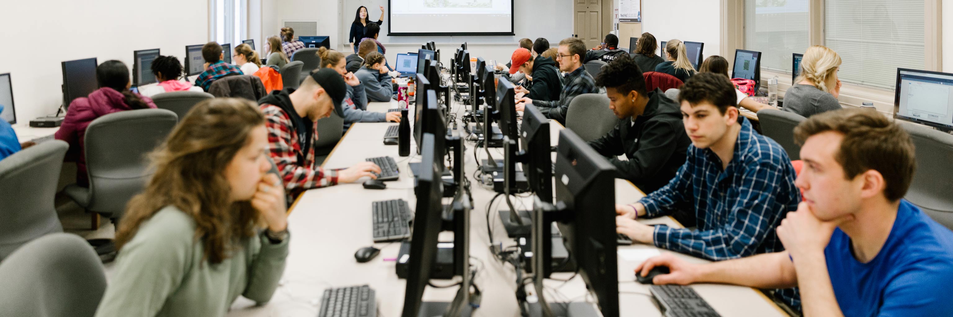 Class of students working a computer lab