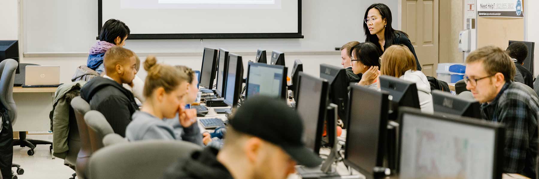 Students working on computers in a geography classroom